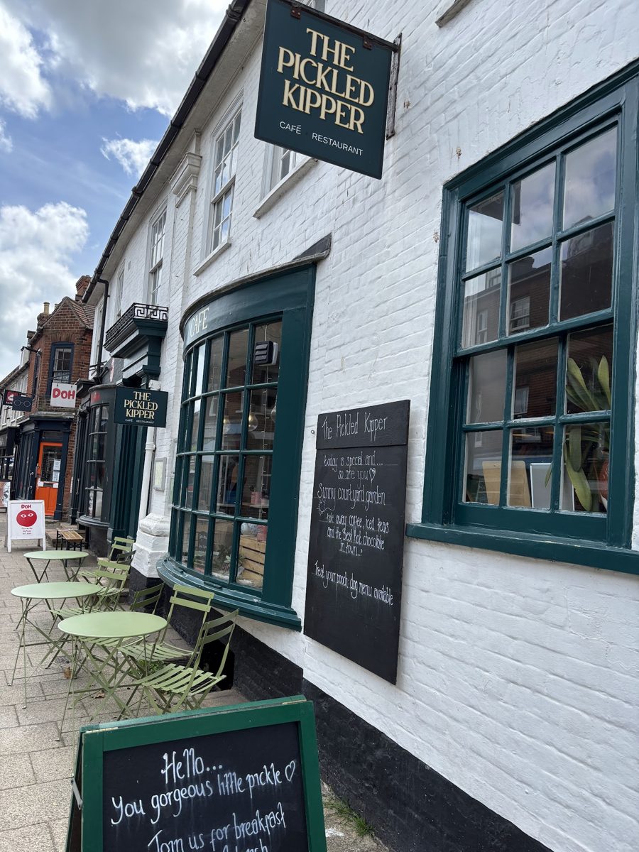 The white-painted front with green windows and The Pickled Kipper hanging sign